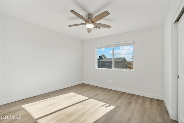 spare room featuring light wood-type flooring and ceiling fan