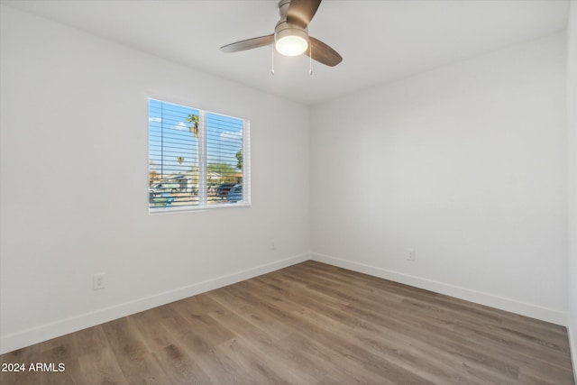 unfurnished room with ceiling fan and hardwood / wood-style flooring