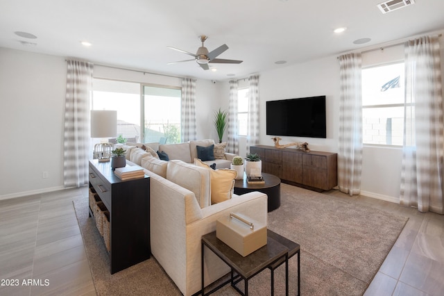 living room featuring light tile patterned floors and ceiling fan