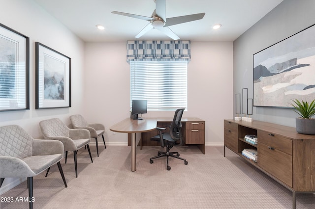 carpeted office space featuring ceiling fan