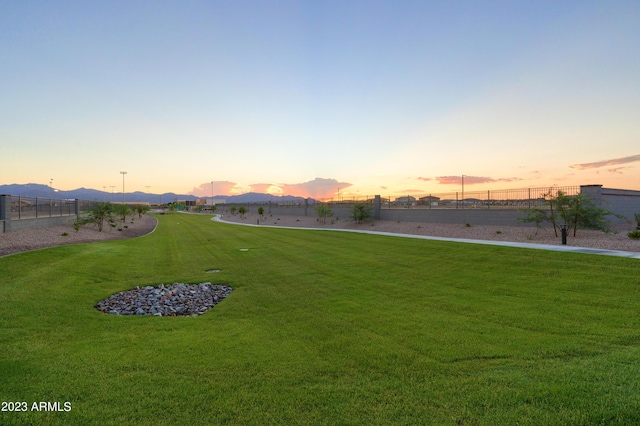 yard at dusk featuring a mountain view