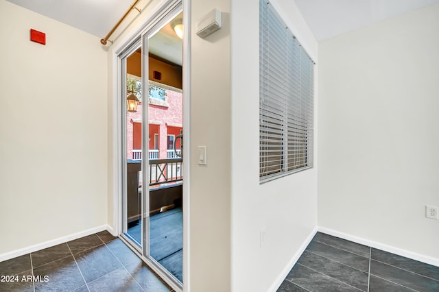 corridor with dark tile patterned flooring