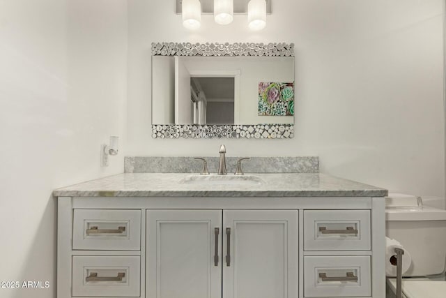 bathroom featuring toilet and vanity