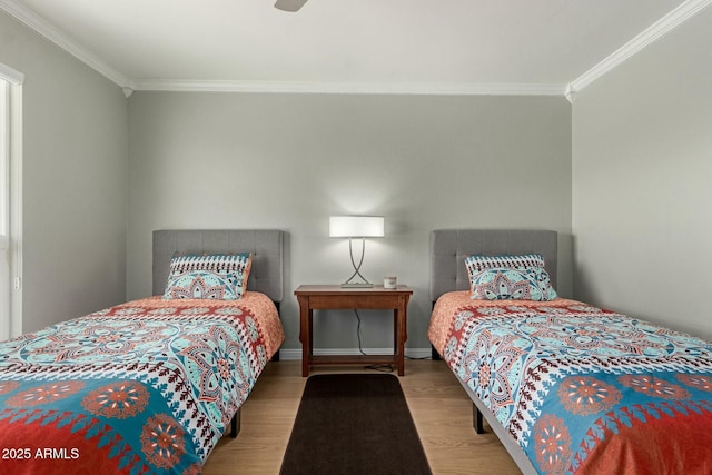 bedroom featuring ornamental molding, wood finished floors, and baseboards