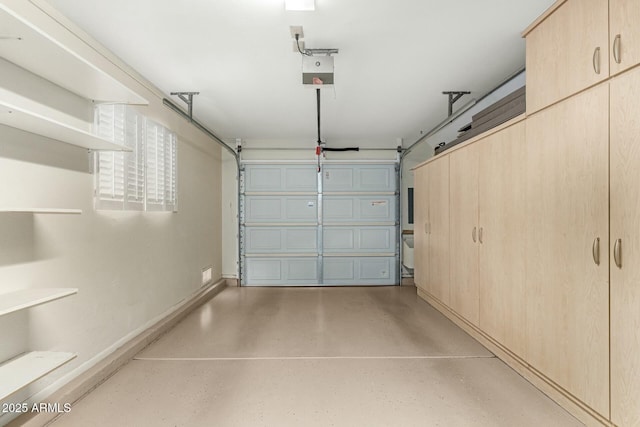 garage with a garage door opener and baseboards