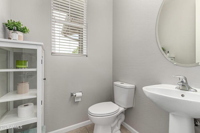14727 W Pasadena Ave, Litchfield Park, AZ 85340 - half bath with baseboards, toilet, a sink, and tile patterned floors