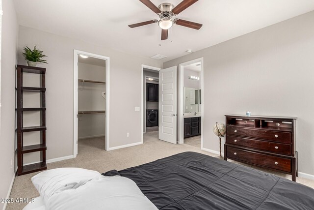 14727 W Pasadena Ave, Litchfield Park, AZ 85340 - bedroom with washer / clothes dryer, baseboards, light colored carpet, and a spacious closet