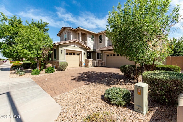 14727 W Pasadena Ave, Litchfield Park, AZ 85340 - view of front of home with an attached garage, driveway, and stone siding