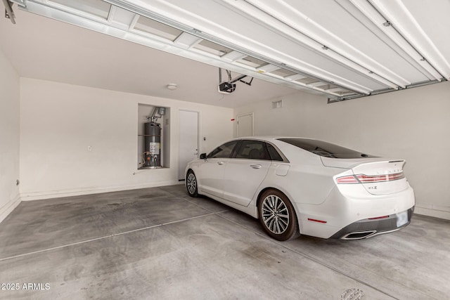 14727 W Pasadena Ave, Litchfield Park, AZ 85340 - garage with strapped water heater, a garage door opener, and baseboards
