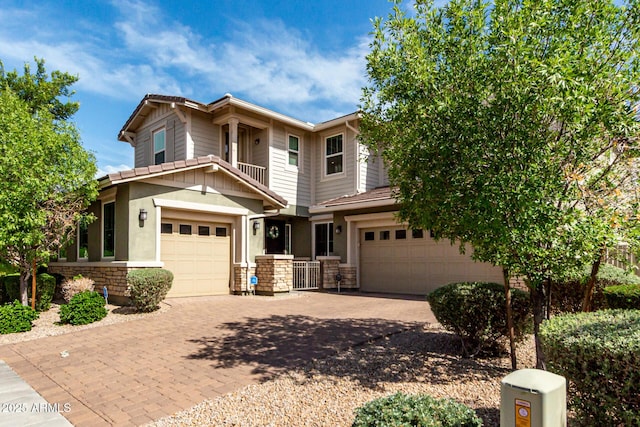 14727 W Pasadena Ave, Litchfield Park, AZ 85340 - view of front of home featuring stone siding, driveway, and a garage