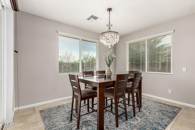 14727 W Pasadena Ave, Litchfield Park, AZ 85340 - dining space featuring plenty of natural light, light tile patterned floors, a chandelier, and baseboards