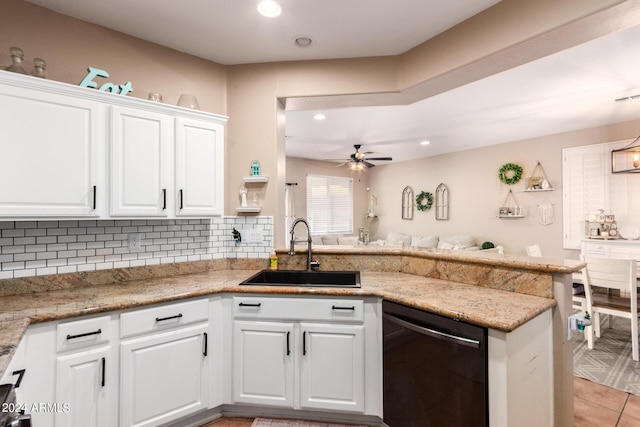 kitchen featuring kitchen peninsula, stainless steel dishwasher, ceiling fan, sink, and white cabinets