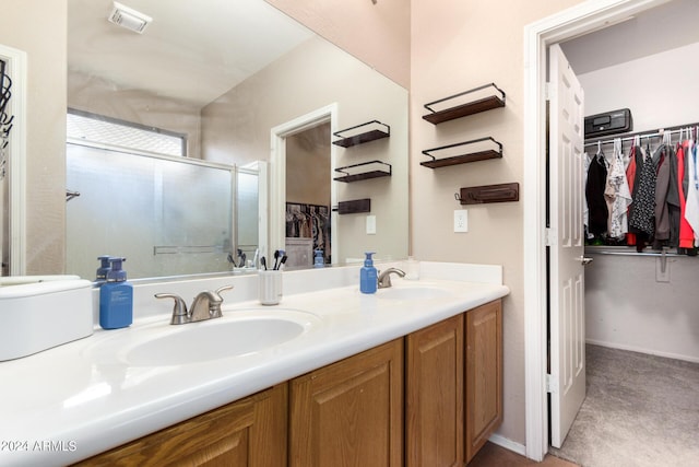 bathroom with vanity and a shower with shower door