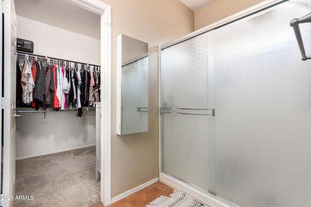 bathroom featuring a shower with shower door