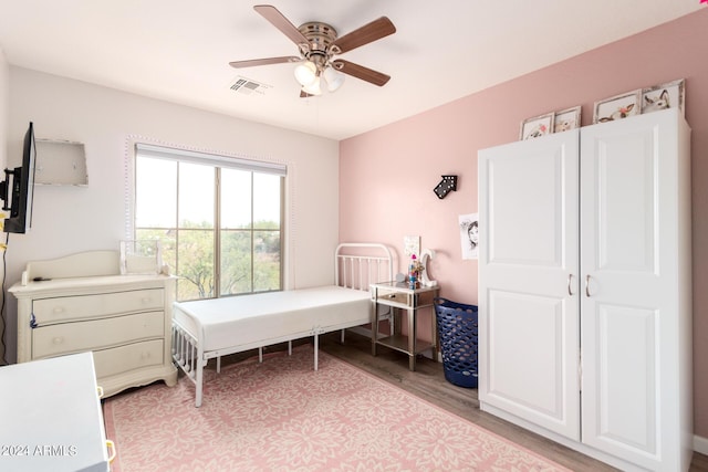 bedroom with ceiling fan and light hardwood / wood-style flooring