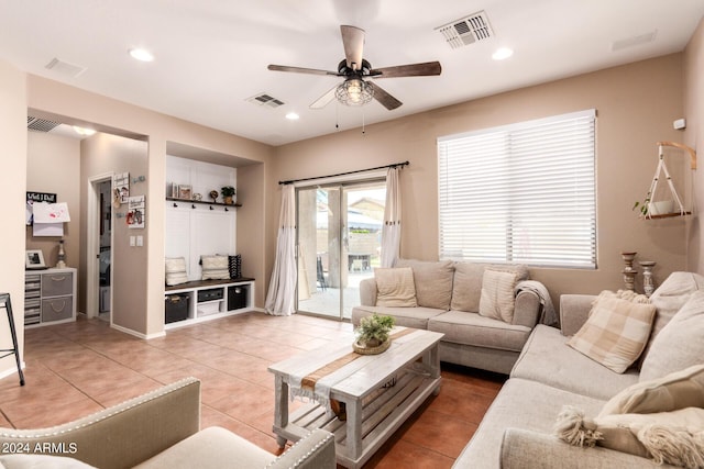 living room with ceiling fan and tile patterned flooring