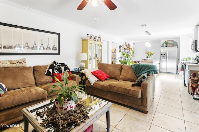 living room featuring crown molding, light tile patterned floors, and ceiling fan