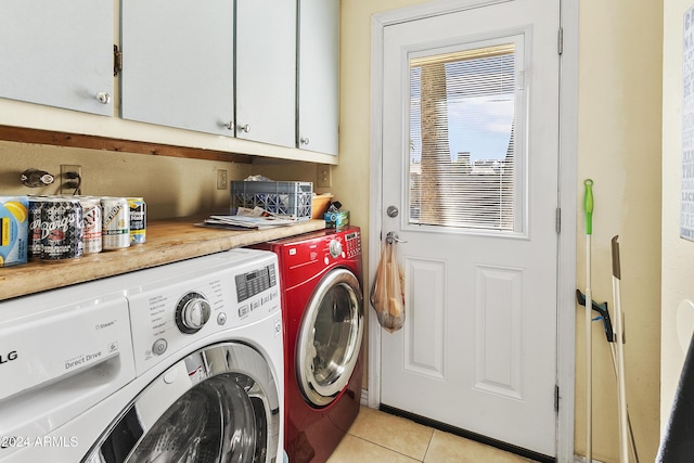 laundry room with cabinets, independent washer and dryer, and light tile patterned floors