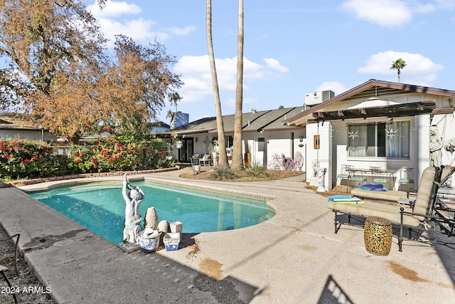 view of swimming pool featuring a patio and cooling unit