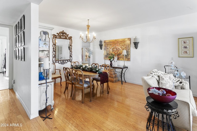 dining area featuring a chandelier and light hardwood / wood-style floors