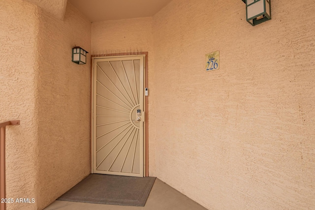 view of exterior entry featuring stucco siding