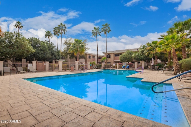 community pool featuring a patio and fence