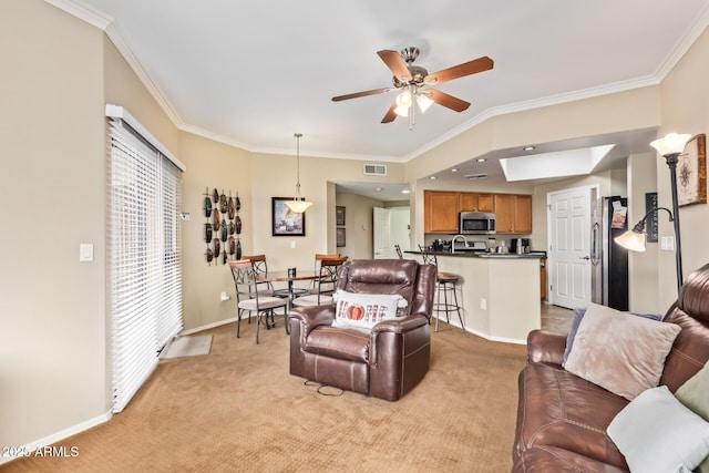 living room featuring light carpet, visible vents, and crown molding