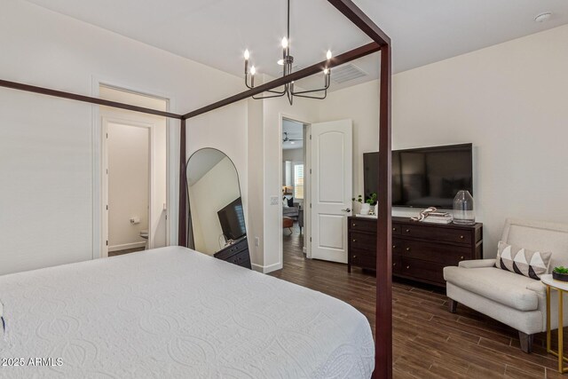 1951 W Plum Rd, Phoenix, AZ 85085 - bedroom with a chandelier, wood finished floors, and baseboards