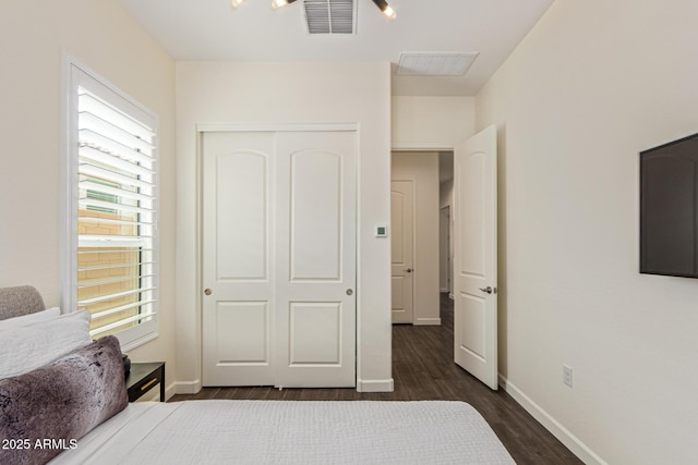 1951 W Plum Rd, Phoenix, AZ 85085 - bedroom with dark wood-type flooring, a closet, and baseboards