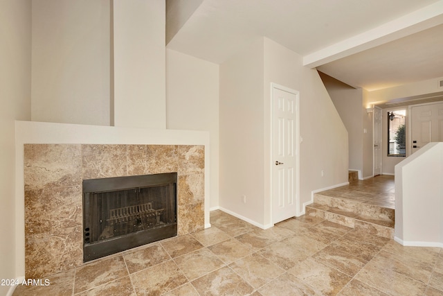 unfurnished living room with a tile fireplace