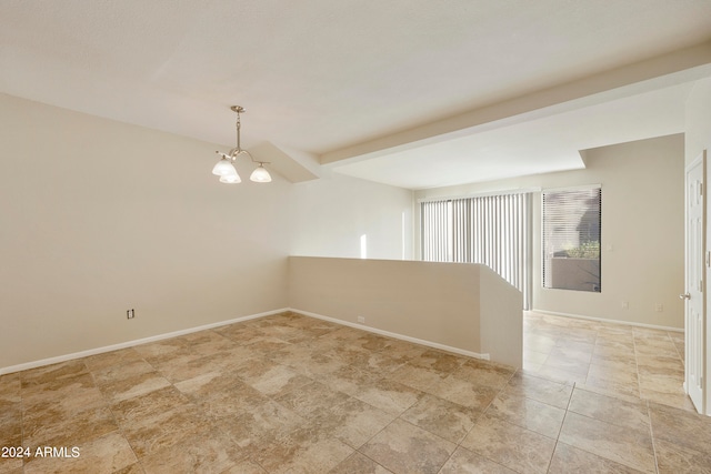 unfurnished room with a notable chandelier and beam ceiling