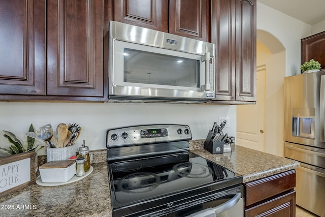 kitchen featuring stone counters and stainless steel appliances