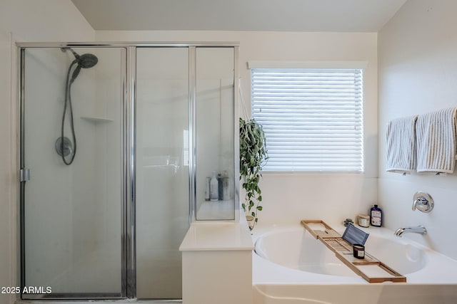 bathroom featuring separate shower and tub