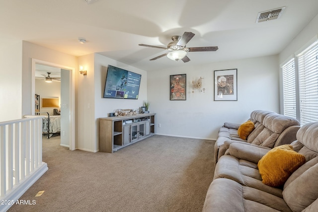 living room featuring ceiling fan and light colored carpet