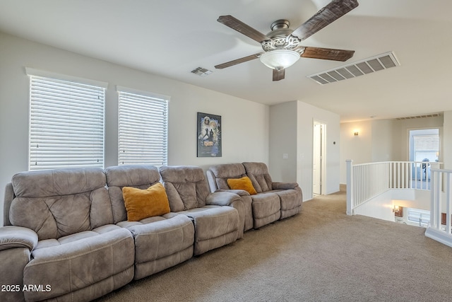 carpeted living room featuring ceiling fan