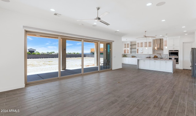 unfurnished living room with a ceiling fan, recessed lighting, dark wood-style flooring, and visible vents