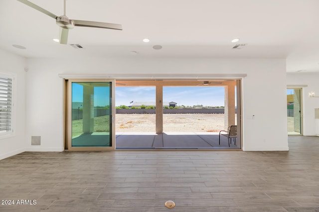 interior space with baseboards, visible vents, and wood finished floors