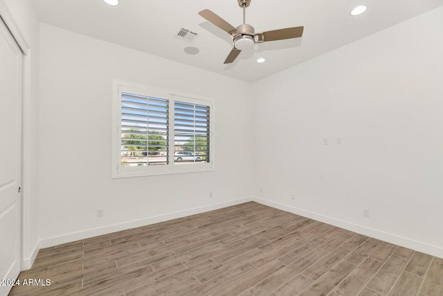 spare room featuring light wood-style floors, baseboards, and recessed lighting