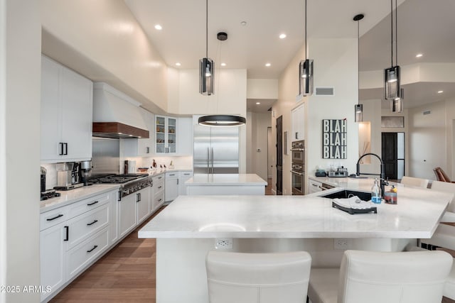 28768 N 95th Way, Scottsdale, AZ 85262 - kitchen featuring appliances with stainless steel finishes, a center island, a kitchen breakfast bar, glass insert cabinets, and white cabinets