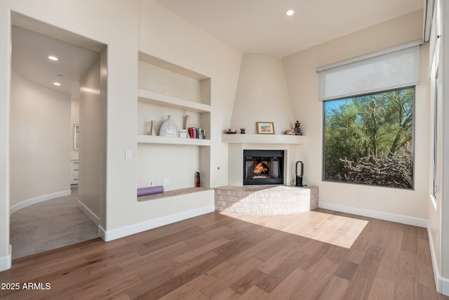 28768 N 95th Way, Scottsdale, AZ 85262 - living area with wood finished floors, built in shelves, recessed lighting, and a large fireplace