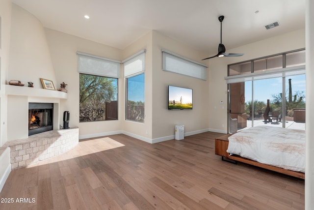 28768 N 95th Way, Scottsdale, AZ 85262 - bedroom with access to exterior, wood finished floors, a brick fireplace, and recessed lighting