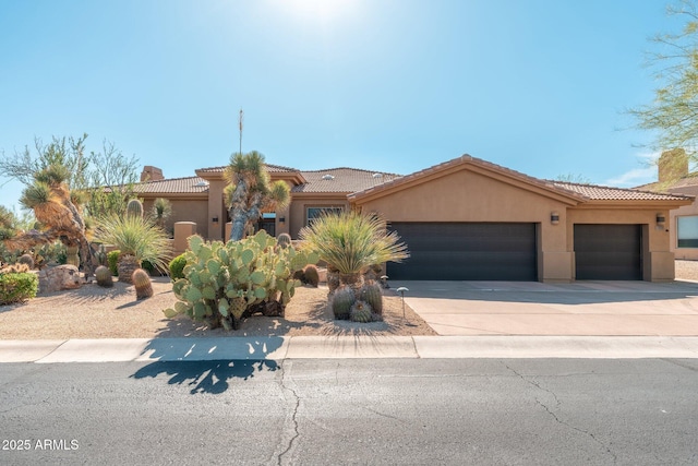 28768 N 95th Way, Scottsdale, AZ 85262 - mediterranean / spanish-style home featuring an attached garage, concrete driveway, stucco siding, a chimney, and a tiled roof
