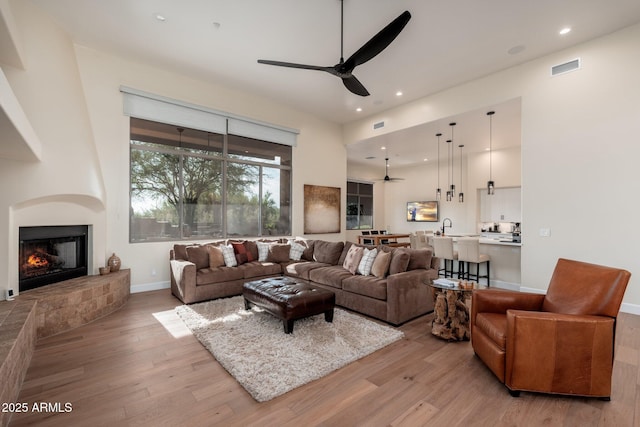 28768 N 95th Way, Scottsdale, AZ 85262 - living area with ceiling fan, light wood-style floors, a large fireplace, and recessed lighting