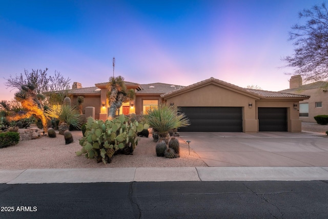 28768 N 95th Way, Scottsdale, AZ 85262 - mediterranean / spanish home featuring a garage, driveway, stucco siding, and a tiled roof