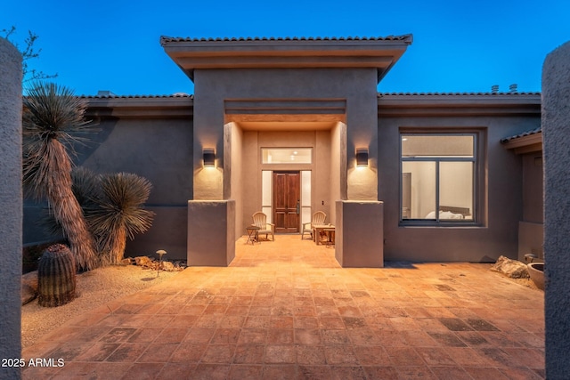 28768 N 95th Way, Scottsdale, AZ 85262 - doorway to property with stucco siding, a tiled roof, and a patio area