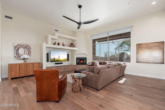28768 N 95th Way, Scottsdale, AZ 85262 - living area featuring light wood-style floors, ceiling fan, a glass covered fireplace, and recessed lighting
