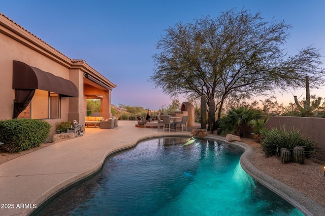 28768 N 95th Way, Scottsdale, AZ 85262 - pool at dusk featuring a patio and an outdoor living space