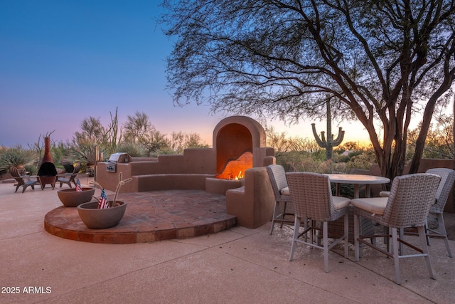 28768 N 95th Way, Scottsdale, AZ 85262 - view of patio with a warm lit fireplace and outdoor dining space