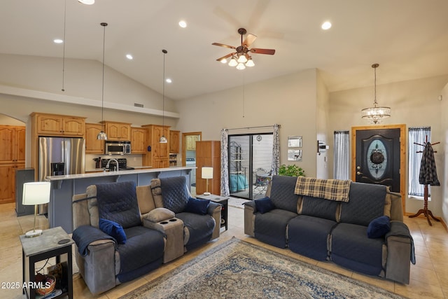 living area featuring light tile patterned floors, recessed lighting, high vaulted ceiling, and ceiling fan with notable chandelier