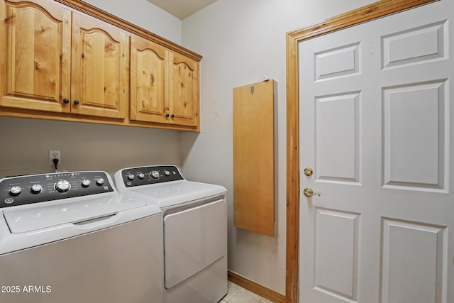 laundry room with cabinet space, baseboards, and separate washer and dryer